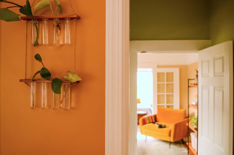 Hanging vases in orange room.