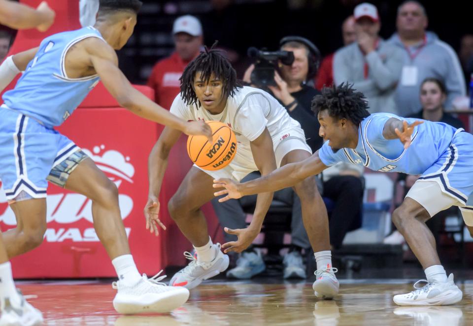 A loose ball hangs between Bradley's Demarion Burch, middle, Indiana State's Julian Larry, left, and Isaiah Swope in the second half of the Braves' MVC basketball home opener Saturday, Dec. 2, 2023 at Carver Arena in Peoria. The Braves fell to the Sycamores 85-77.