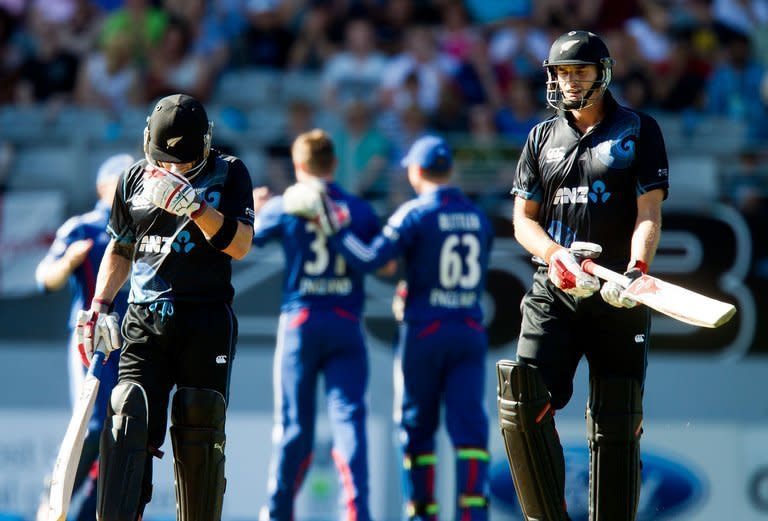 New Zealand's Brendon McCullum (L) hides his face as team-mate Kane Williamson walks off after being caught during the third one-day international against England Auckland on February 23, 2013. New Zealand cumbled to 185 all out at Eden Park
