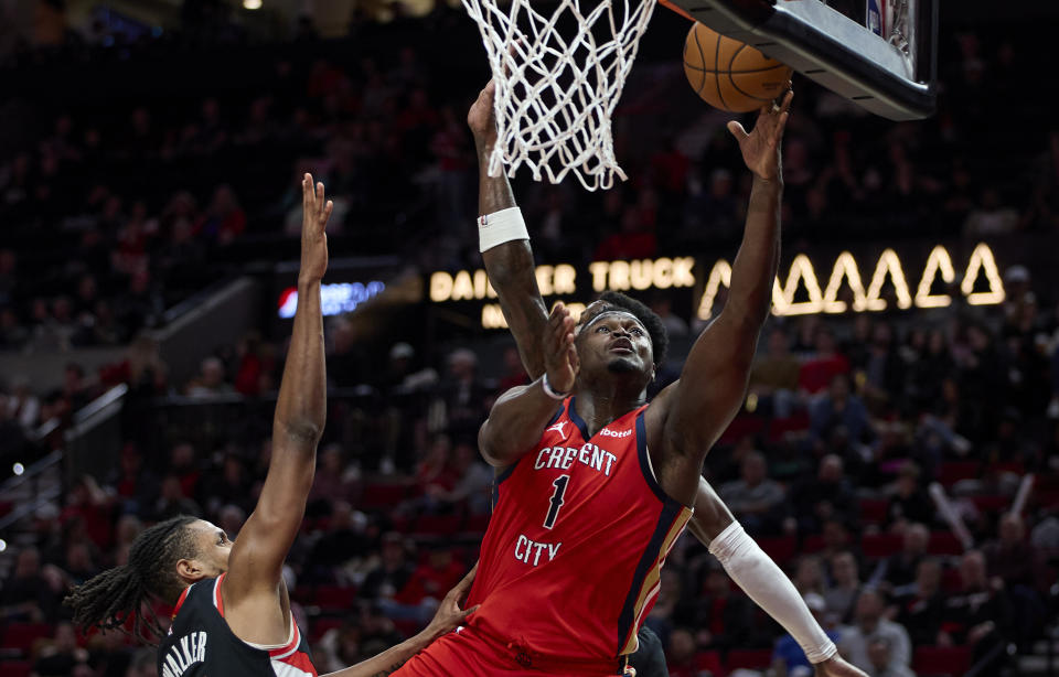 New Orleans Pelicans forward Zion Williamson (1) shoots over Portland Trail Blazers forward Jabari Walker during the second half of an NBA basketball game in Portland, Ore., Tuesday, April 9, 2024. (AP Photo/Craig Mitchelldyer)