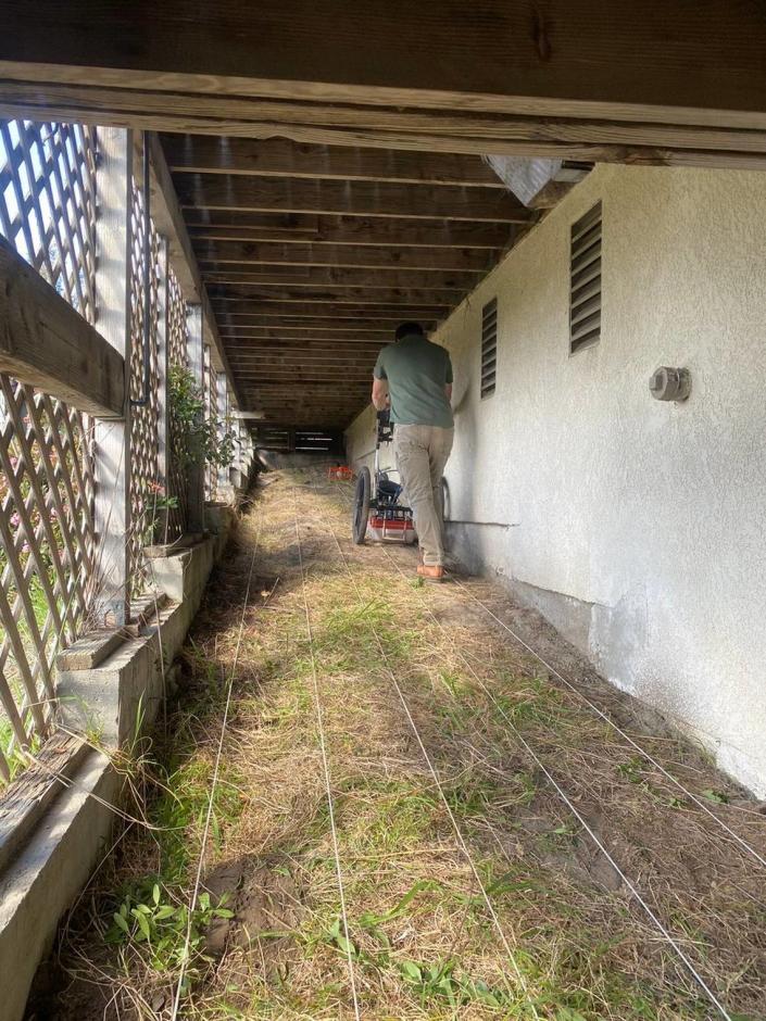 A radar operator examines the land below the deck of the Arroyo Grande home of Ruben Flores, father of Paul Flores.  According to trial testimony, human blood was found under the bridge.