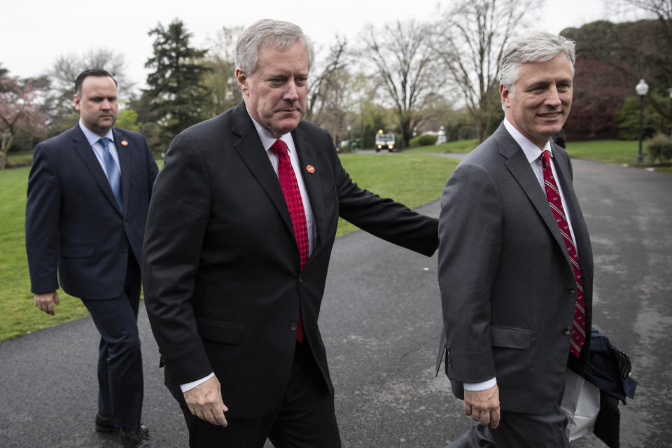 White House Social Media Director Dan Scavino, left, Acting White House Chief of Staff Mark Meadows, and National Security Adviser Robert O'Brien, walk to the West Wing as they return to the White House, Saturday, March 28, 2020, in Washington. President Donald Trump is returning from Norfolk, Va., for the sailing of the USNS Comfort, which is headed to New York. (AP Photo/Alex Brandon)