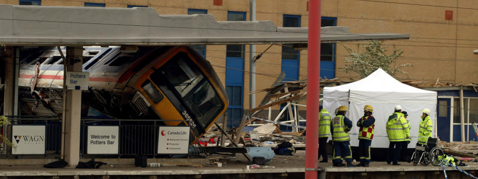 405197 03: A commuter train lies derailed at Potter's Bar Railway Station May 10, 2002 in Hertfordshire, England. The commuter train derailed while coming into the station, resulting in five deaths and dozens of injuries. A report that the train hit an object on the rails has not been confirmed. (Photo by Sion Touhig/Getty Images)