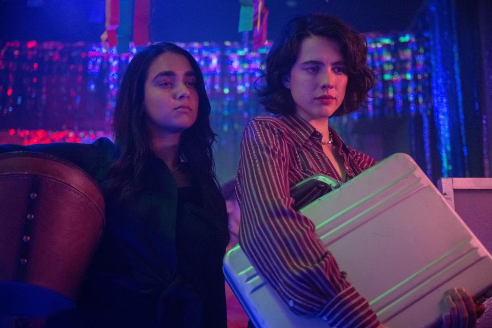 Geraldine Viswanathan (left) and Margaret Qualley play friends on a road trip to Tallahassee who wind up with a wanted briefcase in the crime comedy "Drive-Away Dolls."