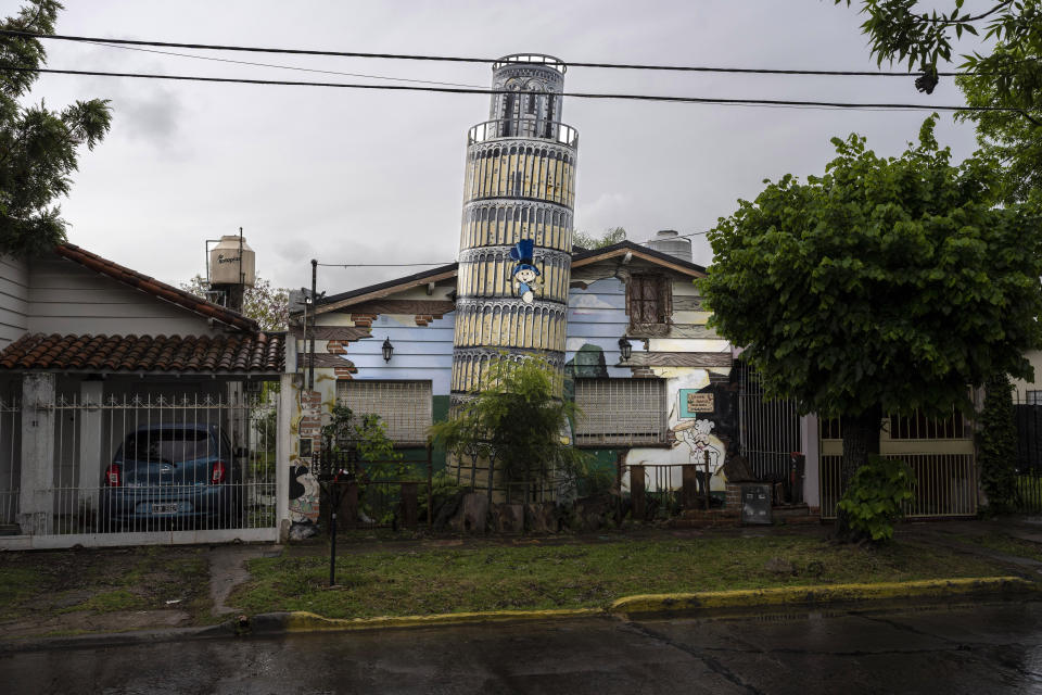 A replica of a leaning Tower of Pisa constructed by artist and architect Rubén Díaz, adorns a private garden in Ituzaingo, Argentina, Saturday, Oct. 15, 2022. Replicas of several European masterworks in the municipality were carried out by Díaz, who is considered a “generator of fantasies.” Díaz's goal is in part to let his neighbors "travel” to places they would normally never see. (AP Photo/Rodrigo Abd)