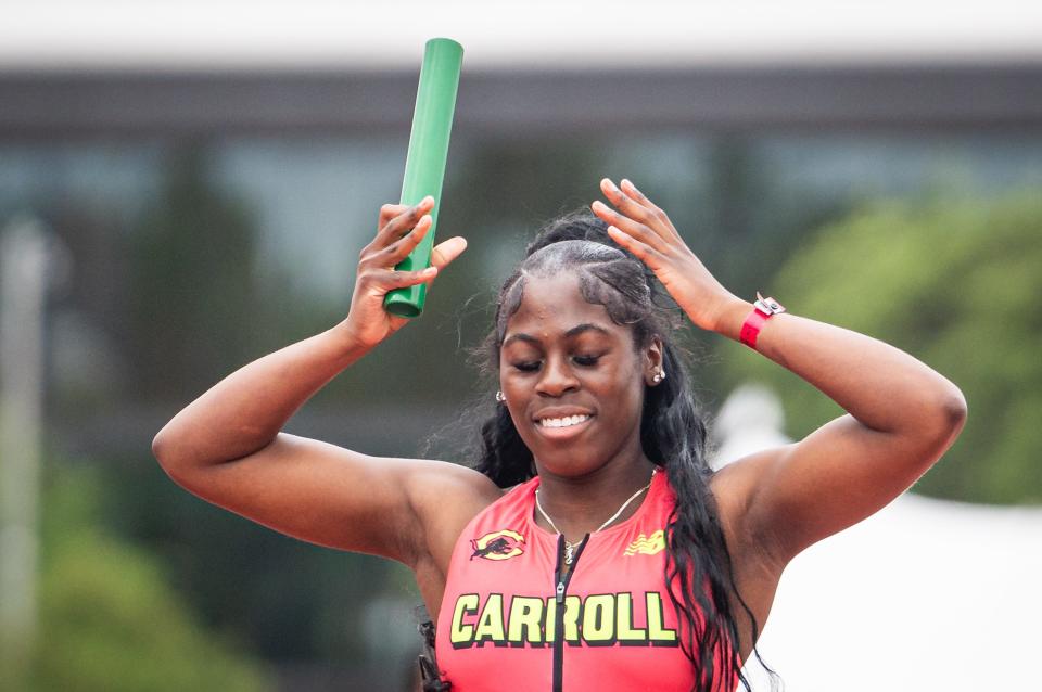 Simisola Balogun of Archbishop Carroll smiles after winning the 800-meter relay Saturday.