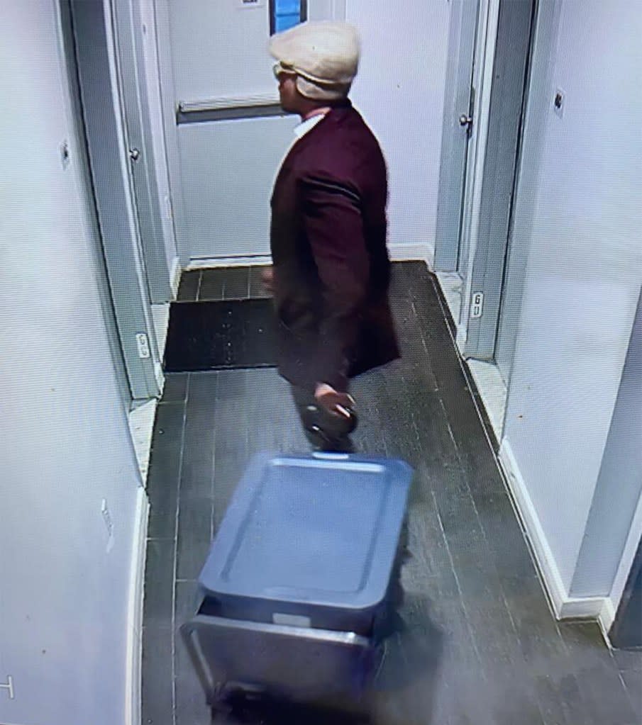 Johnson with a blue bin in the hallway. Obtained by NY Post