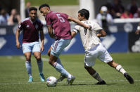 Colorado Rapids defender Auston Trusty (5) fights for control of the ball with Los Angeles FC forward Carlos Vela, right, in the first half of an MLS soccer match Saturday, May 14, 2022, in Commerce City, Colo. (AP Photo/David Zalubowski)