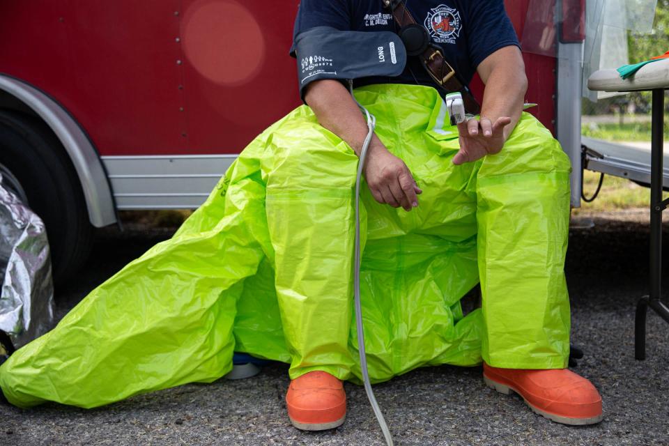 Corpus Christi firefighter and engineer Chris DeLeon has his vital signs read during a mock hazmat scenario at the Hilltop Community Center in Corpus Christi on Aug. 11, 2022. DeLeon is on the first entry team responsible for evaluating hazards and taking instrument readings.