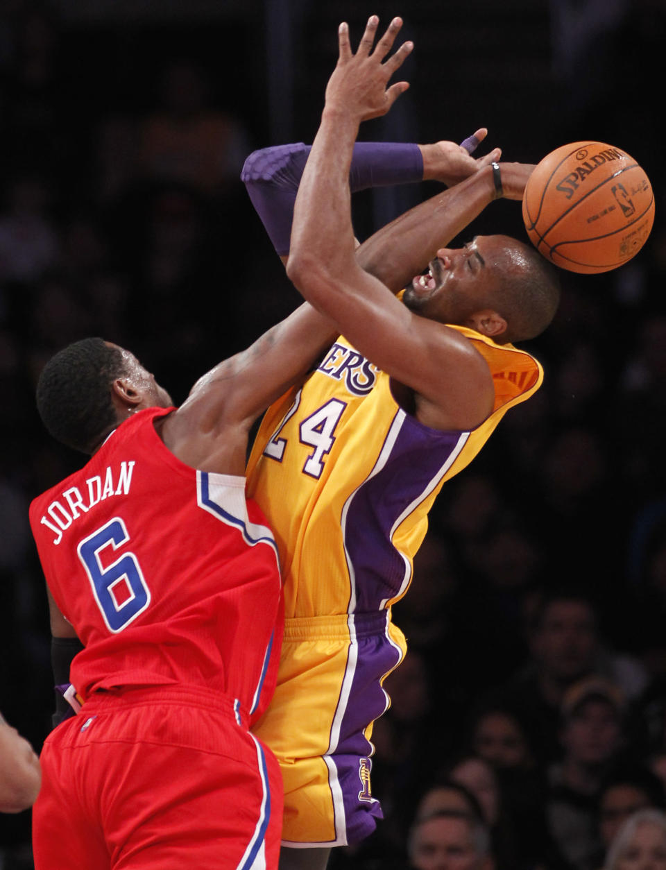 Los Angeles Clippers' DeAndre Jordan, left, fouls Los Angeles Lakers' Kobe Bryant, right, during the first half of an NBA preseason basketball game in Los Angeles on Monday, Dec. 19, 2010. (AP Photo/Danny Moloshok)