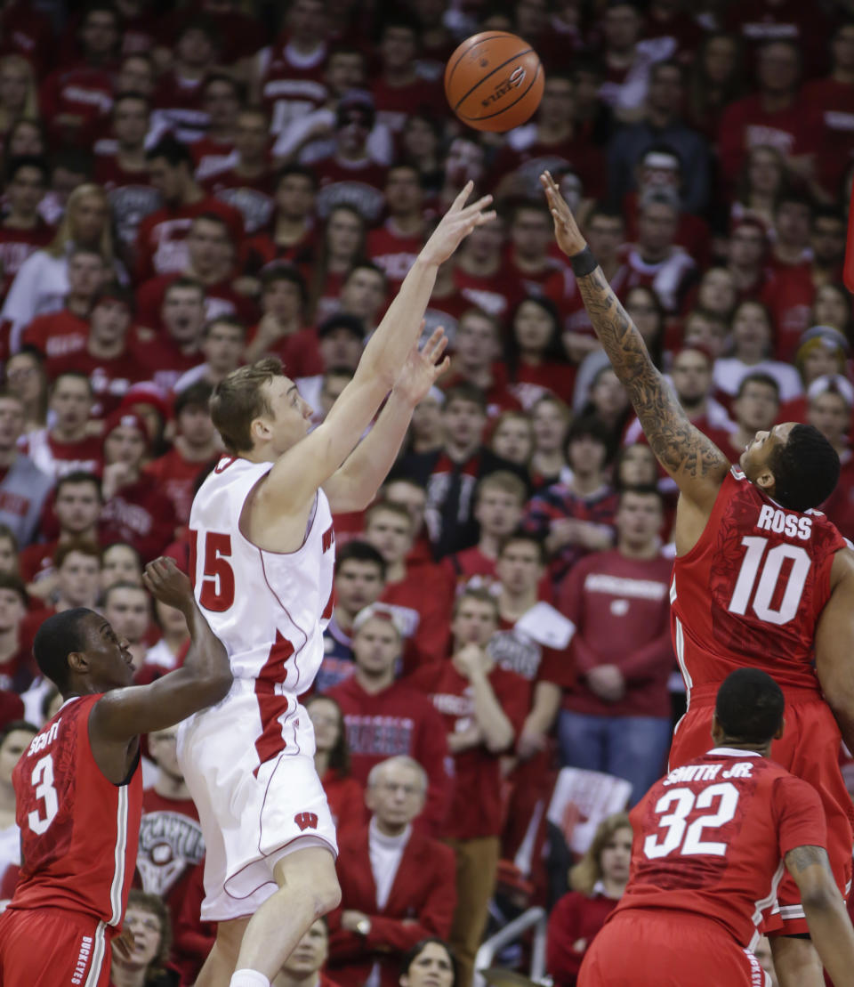 Wisconsin's Sam Dekker (15) shoots over Ohio State's Shannon Scott, left, and LaQuinton Ross during the first half of an NCAA college basketball game Saturday, Feb. 1, 2014, in Madison, Wis. (AP Photo/Andy Manis)