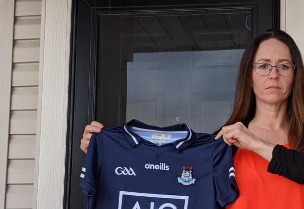 Michelle Sinclair says she found out the hard way that 'import duty/tax and clearance fees' owed on an imported Irish football jersey were mostly processing fees that went to DHL. (Colin Hall/CBC - image credit)