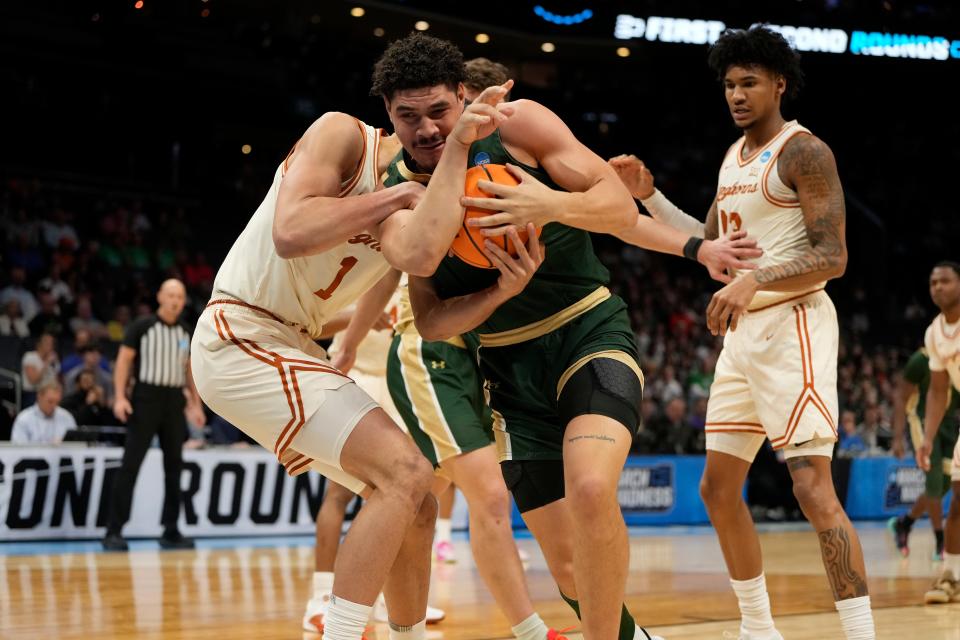 Texas forward Dylan Disu, left, defends against Colorado State's Joel Scott in the Longhorns' 56-44 win in a NCAA Tournament first-round game Thursday at the Spectrum Center in Charlotte, N.C. The Longhorns advanced to face either Tennessee or Saint Peter's on Saturday.