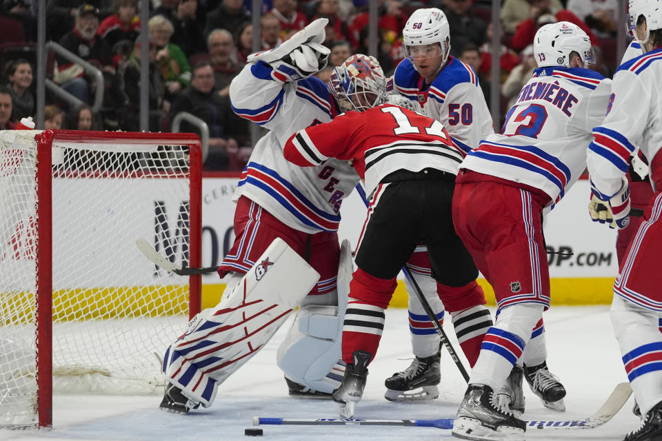 New York Rangers goaltender Igor Shesterkin, left, and Chicago Blackhawks left wing Nick Foligno scuffle during the first period of an NHL hockey game Friday, Feb. 9, 2024, in Chicago. (AP Photo/Erin Hooley)