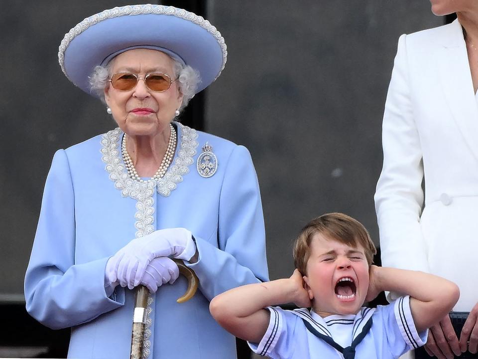 Queen Elizabeth stands next to Prince Louis as he screams and covers his ears at Trooping the Colour 2022.