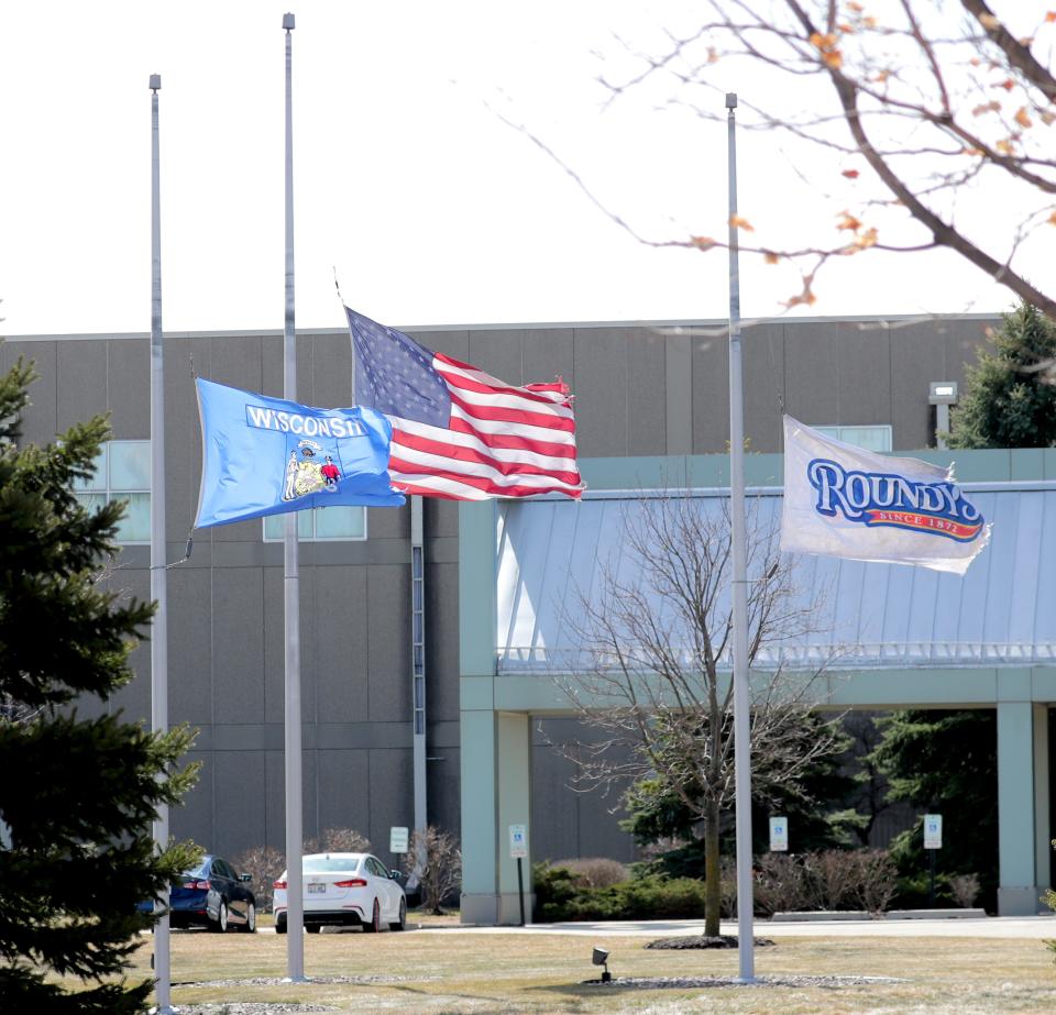 Flags fly at half-staff at the Roundy's warehouse in Oconomowoc on Thursday, March 18, 2021.