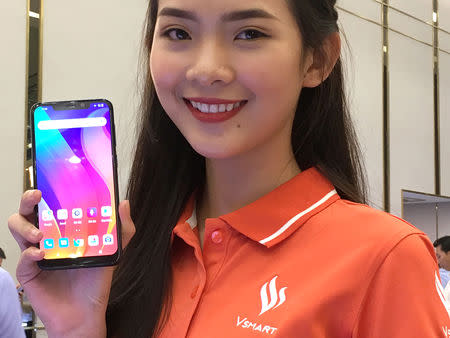 A woman shows a Vingroup's Vsmart phone during the launching ceremony in Ho Chi Minh City, Vietnam December 14, 2018. REUTERS/Mai Nguyen