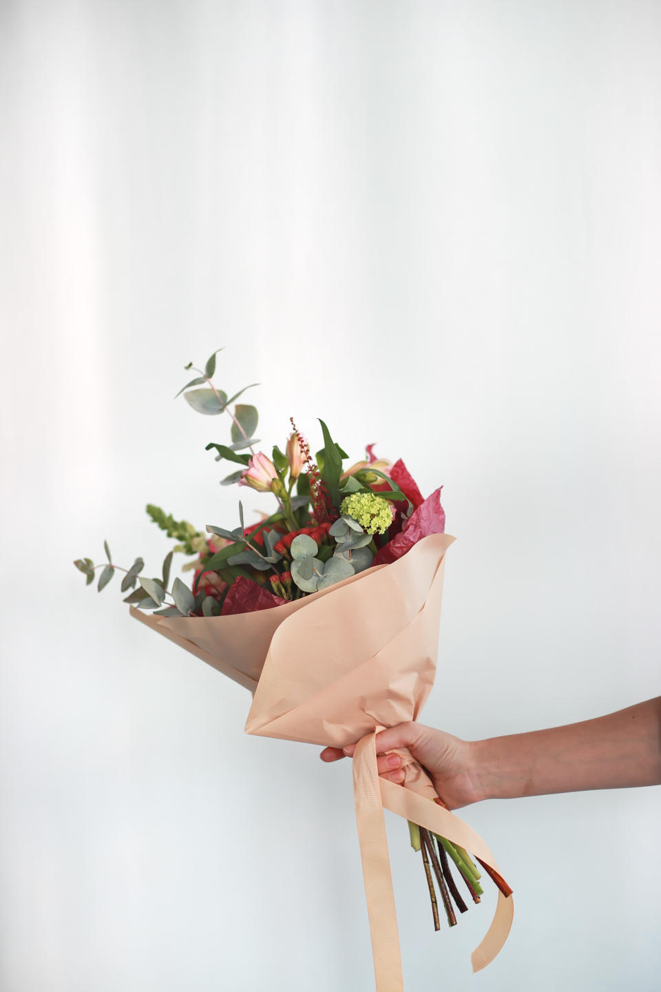 a person holding a bouquet of flowers