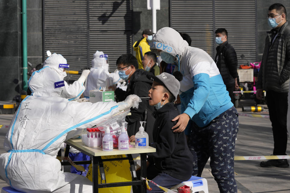 Residents get tested for the coronavirus at an outdoor facility on Monday, March 14, 2022, in Beijing. China's mainland reported 1,337 domestically transmitted COVID cases Monday across dozens of cities, part of a surge driven by the variant commonly known as "stealth omicron," with the vast majority of cases reported in far northeastern Jilin province. (AP Photo/Ng Han Guan)