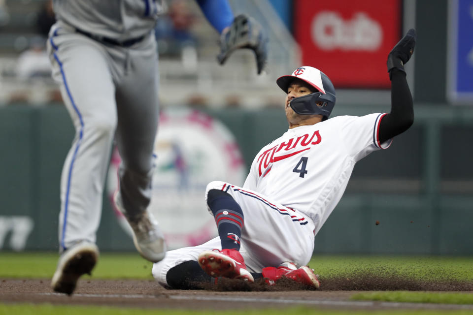 Minnesota Twins' Carlos Correa slides into third base, advancing on a single by Jorge Polanco against the Kansas City Royals during the first inning of a baseball game Thursday, April 27, 2023, in Minneapolis. (AP Photo/Bruce Kluckhohn)