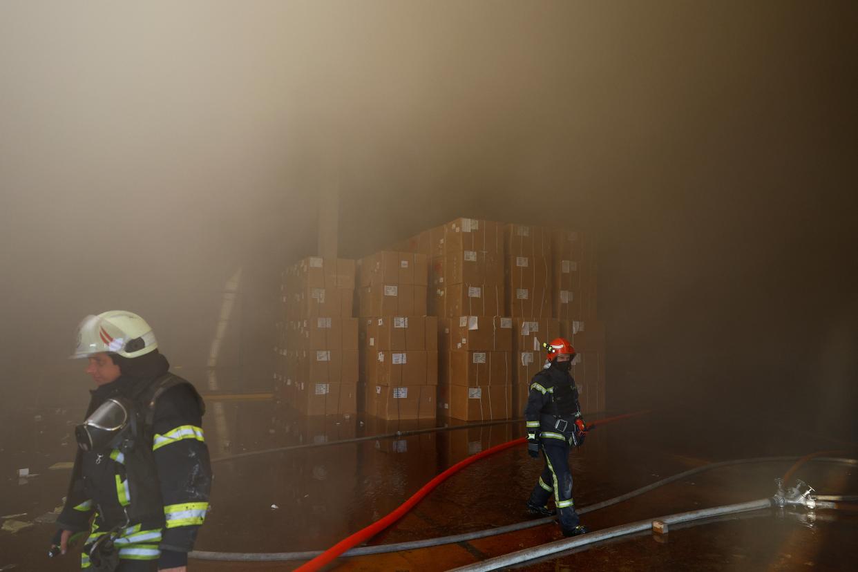 Firefighters work at a site of a tobacco factory damaged during Russian suicide drone strike (REUTERS)