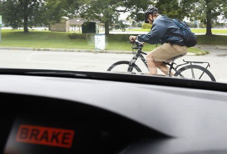 The brake sign is lit on the dashboard screen of an Acura RLX sedan as it avoids a cyclist, during Honda's Omni Directional V2X demonstration at the ITS World Congress in Detroit, Michigan, September 11, 2014. REUTERS/Rebecca Cook