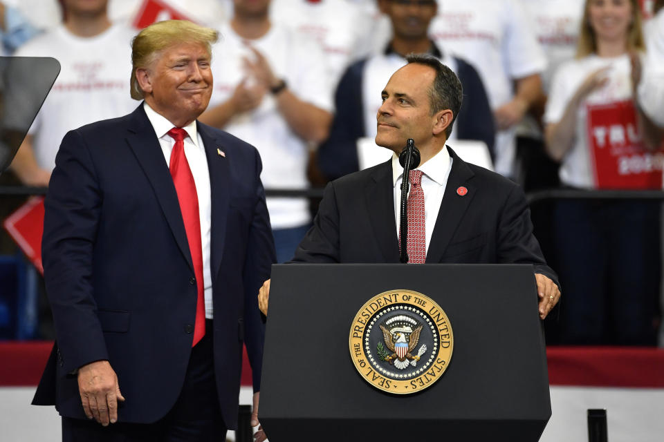 Kentucky Gov. Matt Bevin, right, looks out at the crowd as President Donald Trump watches during a campaign rally in Lexington, Ky., Monday, Nov. 4, 2019. (AP Photo/Timothy D. Easley)