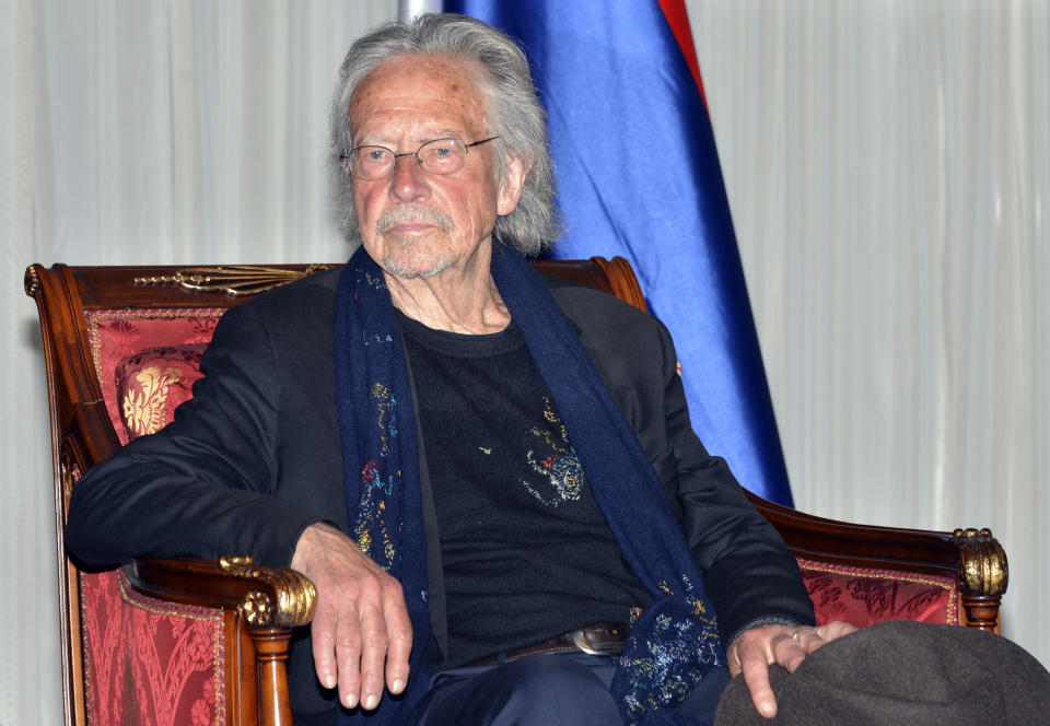 Austrian author Peter Handke listens to President of Republika Srpska Zeljka Cvijanovic during the ceremony in Banja Luka, Bosnia, Friday, May 7, 2021. The 2019 Nobel Literature Prize laureate Peter Handke was on Friday awarded top honors from Bosnian Serbs, building on the controversy stemming from his apologist views over Serb war crimes during the 1990s' wars in the Balkans. (AP Photo/Radivoje Pavicic)