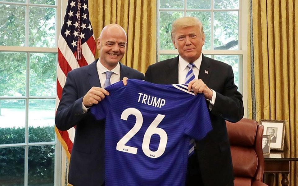 Gianni Infantino (left) presents Donald Trump with a personalised football shirt inside the Oval Office