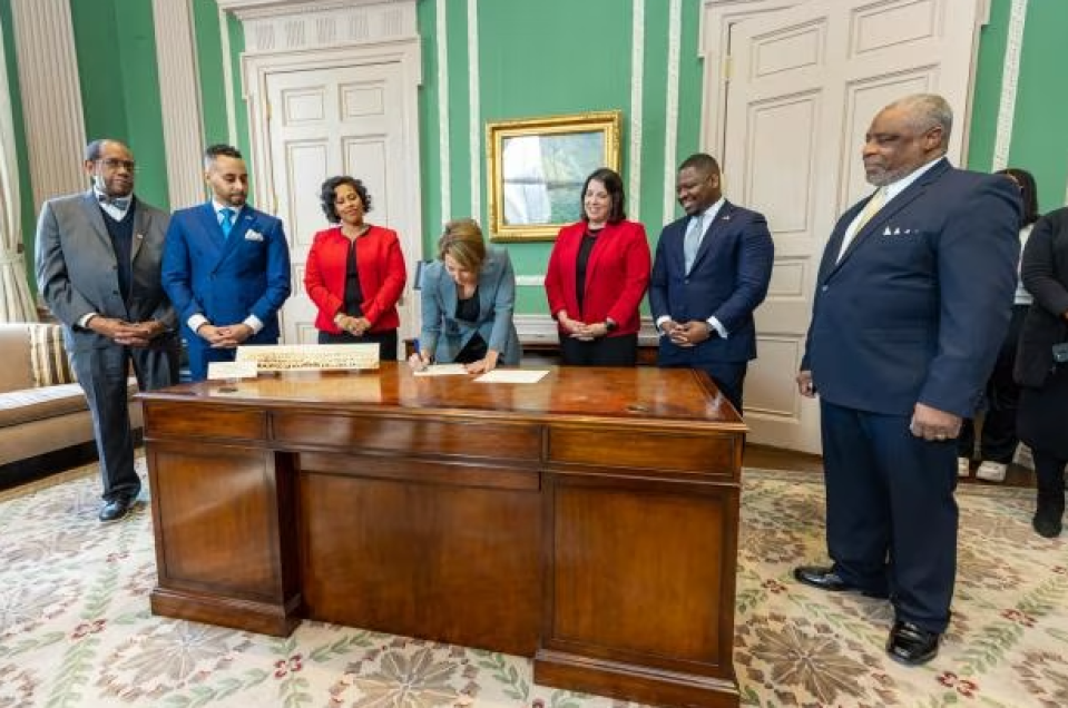 Gov. Maura Healey, center, signs an Executive Order establishing the Governor’s Advisory Council on Black Empowerment on Feb. 27, 2023.