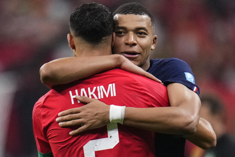 France's Kylian Mbappe hugs Morocco's Achraf Hakimi at the end of the World Cup semifinal soccer match between France and Morocco at the Al Bayt Stadium in Al Khor, Qatar, Wednesday, Dec. 14, 2022. France won 2-0 and will play Argentina in Sunday's final. (AP Photo/Manu Fernandez)