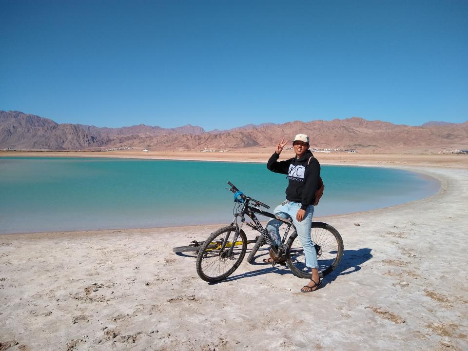 tino roco on bike in front of water