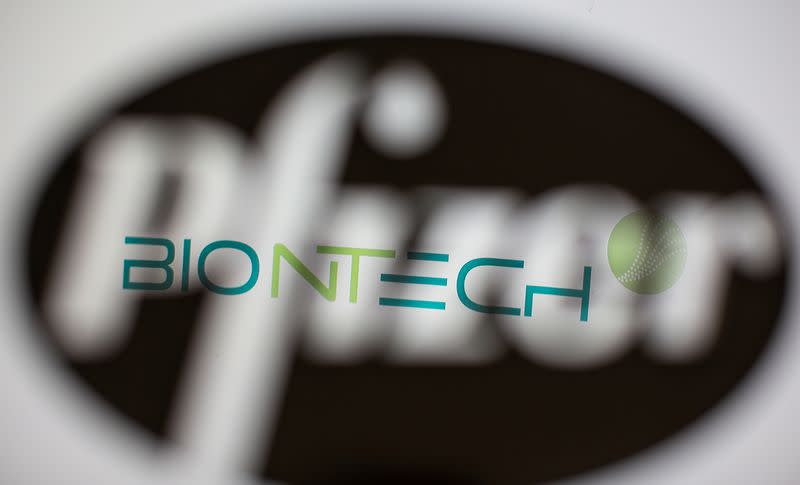 FILE PHOTO: Biontech's logo is seen through a 3D-printed Pfizer logo in this illustration