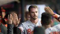 Baltimore Orioles' Trey Mancini is congratulated by teammates after scoring during the third inning of the team's baseball game against the Cleveland Indians, Wednesday, June 16, 2021, in Cleveland. (AP Photo/Tony Dejak)