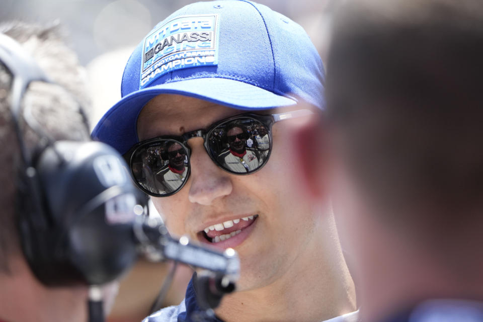 Alex Palou, of Spain, speaks with his crew before the Indianapolis 500 auto race at Indianapolis Motor Speedway in Indianapolis, Sunday, May 29, 2022. (AP Photo/AJ Mast)