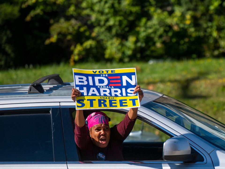 A Biden supporter cheers while driving past the A. B. Day School polling location on October 17, 2020 in Philadelphia, Pennsylvania.Mark Makela/ Getty Images