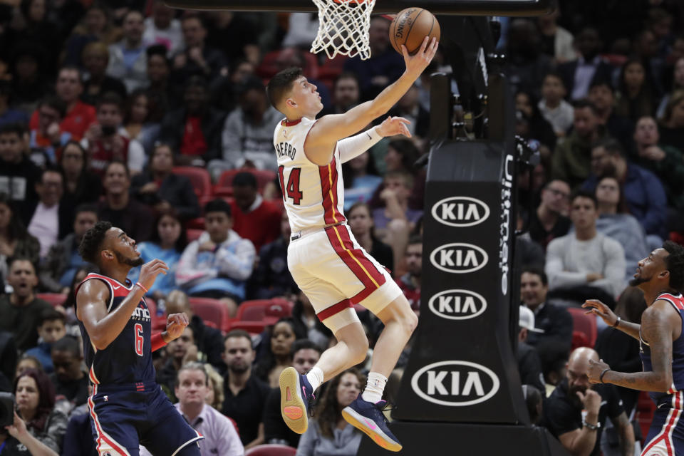 Miami Heat guard Tyler Herro (14) shoots over Washington Wizards guard Troy Brown Jr. (6) and guard Jordan McRae, right, during the first half of an NBA basketball game, Wednesday, Jan. 22, 2020, in Miami. (AP Photo/Lynne Sladky)