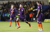 Manchester City's Phil Foden, centre, celebrates after scoring his side's third goal during the English League Cup soccer match between Oxford United and Manchester City at the Kassam Stadium in Oxford, England, Tuesday, Sept. 25, 2018. (AP Photo/Frank Augstein)