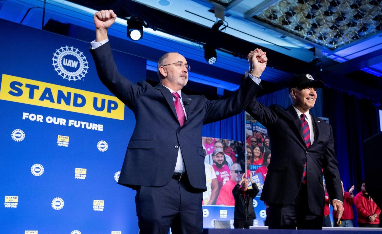 UAW President Shawn Fain, left, clasps hands with President Biden after endorsing his bid for reelection. <a href="https://www.gettyimages.com/detail/news-photo/president-joe-biden-and-shawn-fain-president-of-the-united-news-photo/1950953071?adppopup=true" rel="nofollow noopener" target="_blank" data-ylk="slk:Saul Loeb/AFP via Getty Images;elm:context_link;itc:0;sec:content-canvas" class="link ">Saul Loeb/AFP via Getty Images</a>