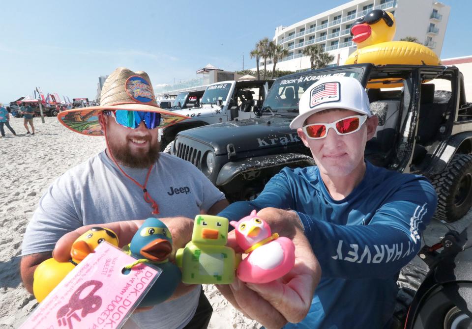 Jeep owners Alex Israel and Jamie Pilgrim show off a few of the many rubber ducks that ride in and on their jeeps along Daytona Beach during last year's Jeep Beach. Jeep owners offer the ducks to other brand loyalists as a gesture of friendship.
