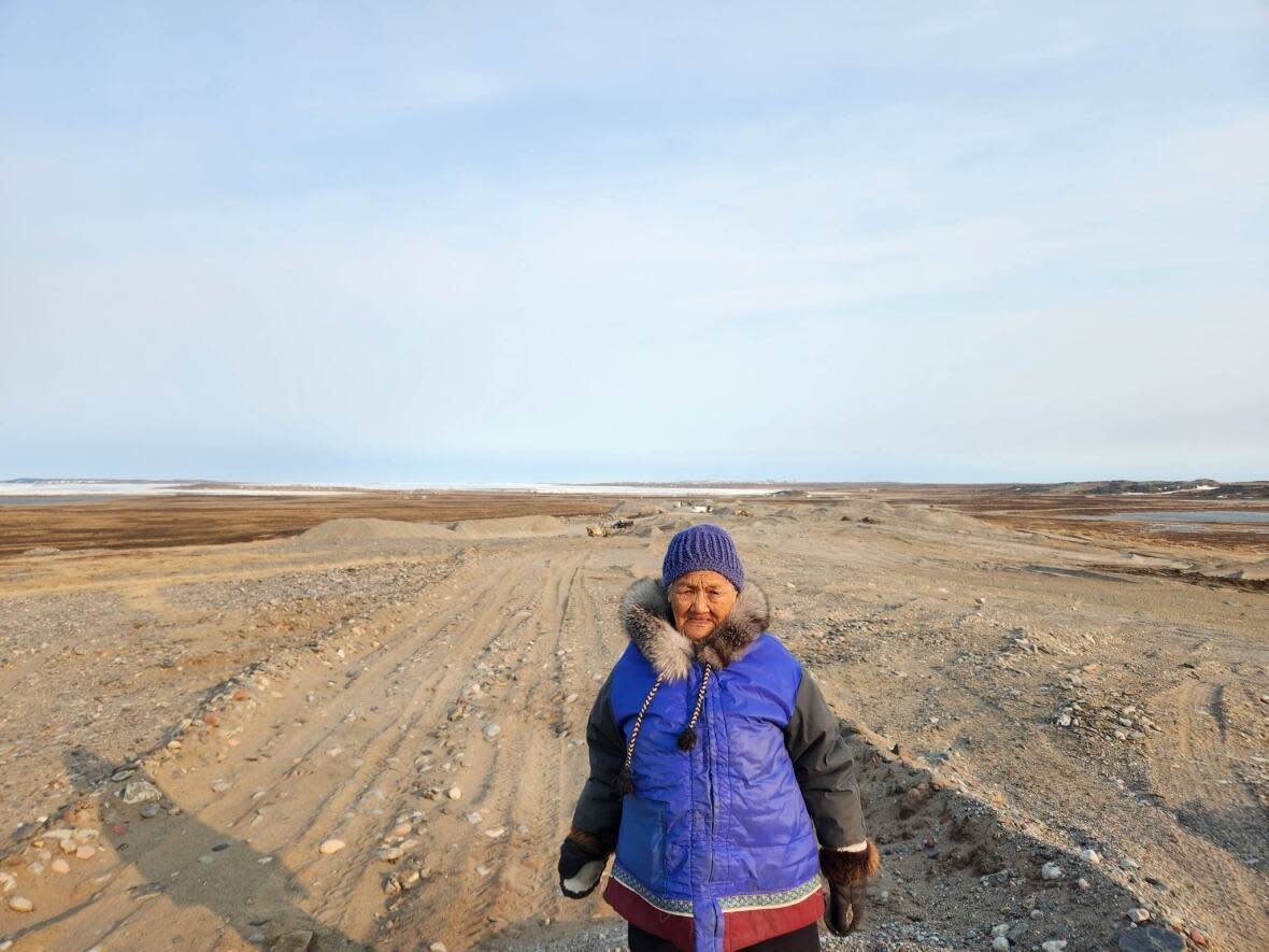 Adele Kumaruaq Angidlik, 90, stands near the site where workers in Rankin Inlet, Nunavut, are digging for gravel. She said her late husband asked to be buried at that site, and she wants to see a buffer zone imposed around his grave. (Submitted by Ada Angidlik - image credit)