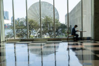 A member of the Irish delegation works on his computer in the main lobby of the United Nations headquarters, Monday, Sept. 21, 2020. In 2020, which marks the 75th anniversary of the United Nations, the annual high-level meeting of world leaders around the U.N. General Assembly will be very different from years past because of the coronavirus pandemic. Leaders will not be traveling to the United Nations in New York for their addresses, which will be prerecorded and most events related to the gathering will be held virtually. (AP Photo/Mary Altaffer)