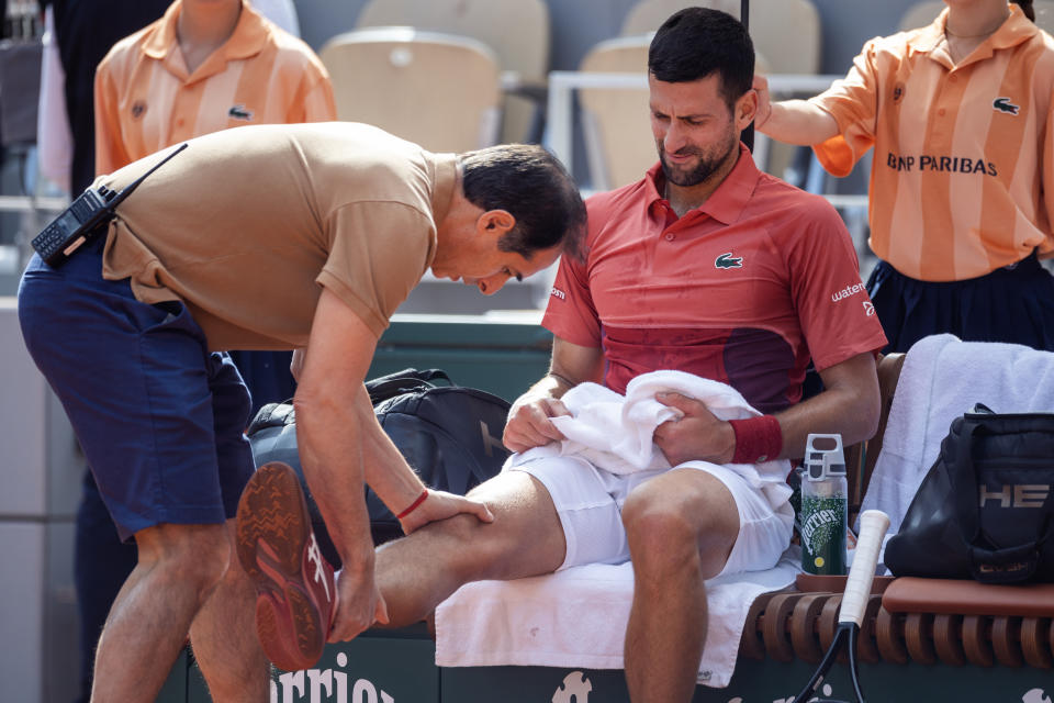 PARIS, FRANCE - June 03: Novak Djokovic of Serbia receives treatment for his knee injury during his match against Francisco Cerundolo of Argentina on Court Philippe-Chatrier during the fourth round of the 2024 French Open Tennis Tournament at Roland Garros on June 3rd, 2024, in Paris, France. (Photo by Tim Clayton/Corbis via Getty Images)