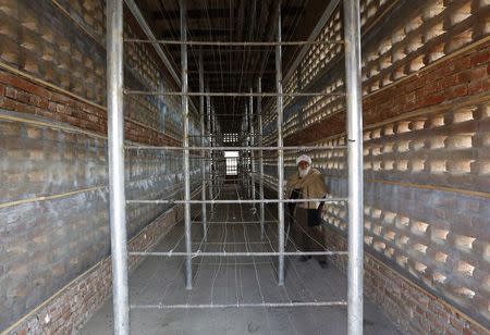 Afghan farmer Mohammad Malik stands inside his grape pitfall which was build by the U.S. Agency for International Development (USAID) project in Parwan province December 13, 2014. REUTERS/Mohammad Ismail