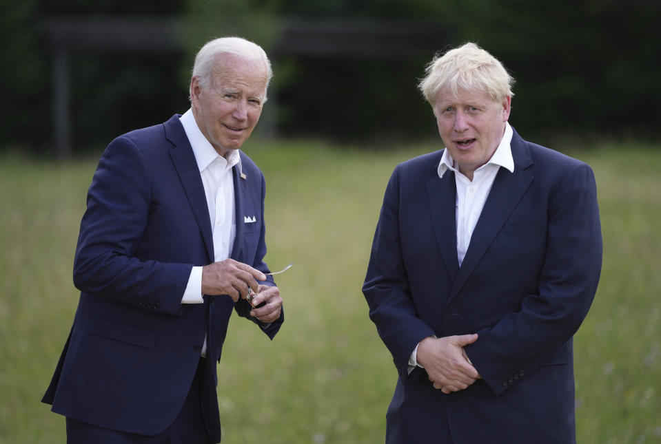 U.S. President Joe Biden, left, speaks with British Prime Minister Boris Johnson during the official G7 group photo at Castle Elmau in Kruen, near Garmisch-Partenkirchen, Germany, on Sunday, June 26, 2022. The Group of Seven leading economic powers are meeting in Germany for their annual gathering Sunday through Tuesday. (AP Photo/Matthias Schrader)