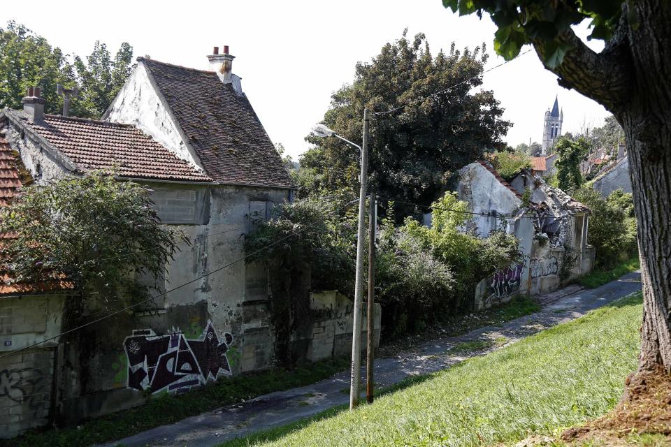 Abandoned houses marked with graffiti in the ghost town of Goussainville-Vieux Pays, just 12 miles from Paris. (Reuters)