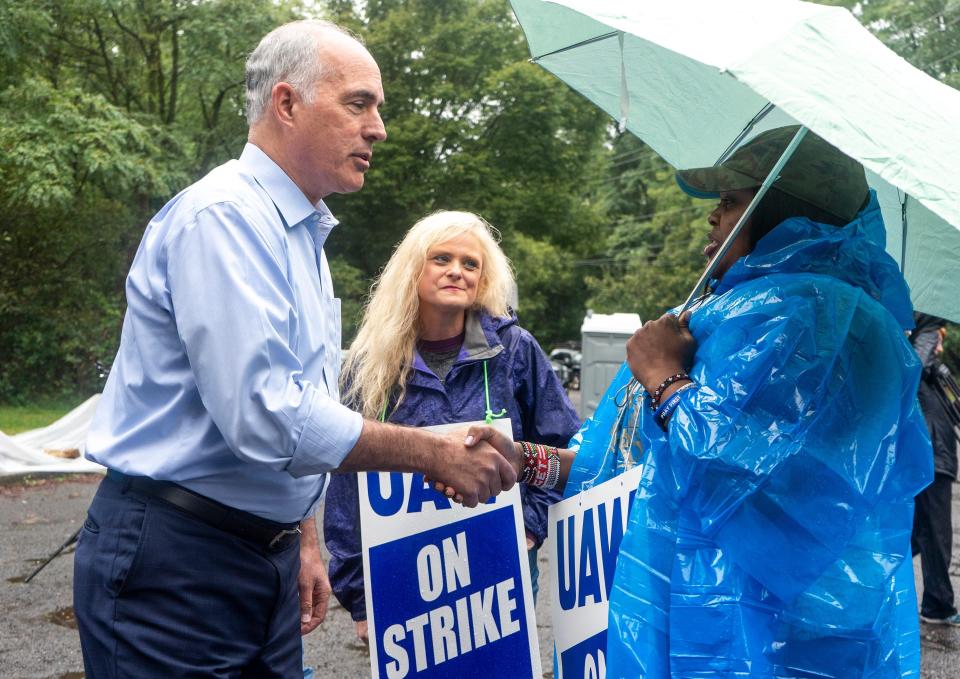 U.S. Sen. Bob Casey, left, talking to Charmian Leslie-Hughes, center, from Lower Makefield Township, and Milka Kiiru, right, from New Falls, as he visits local auto workers and their supporting union members on strike outside General Motors Corp. in Langhorne on Tuesday, Sept. 26, 2023.