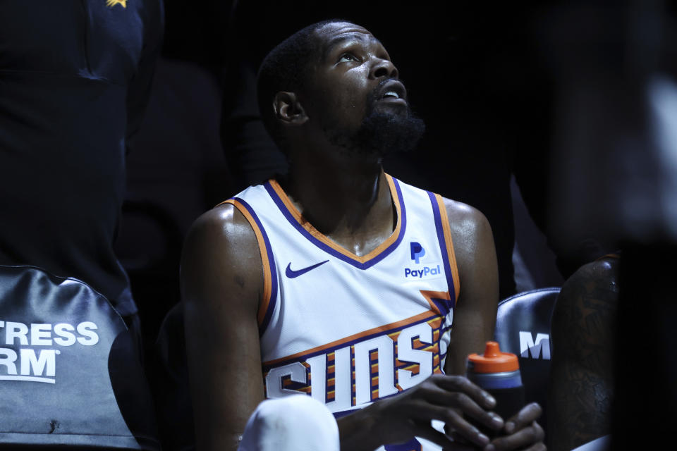 Phoenix Suns forward Kevin Durant sits on the bench during the first half of the team's NBA basketball game against the Sacramento Kings Friday, April 12, 2024, in Sacramento, Calif. The Suns won 108-107. (AP Photo/Benjamin Fanjoy)