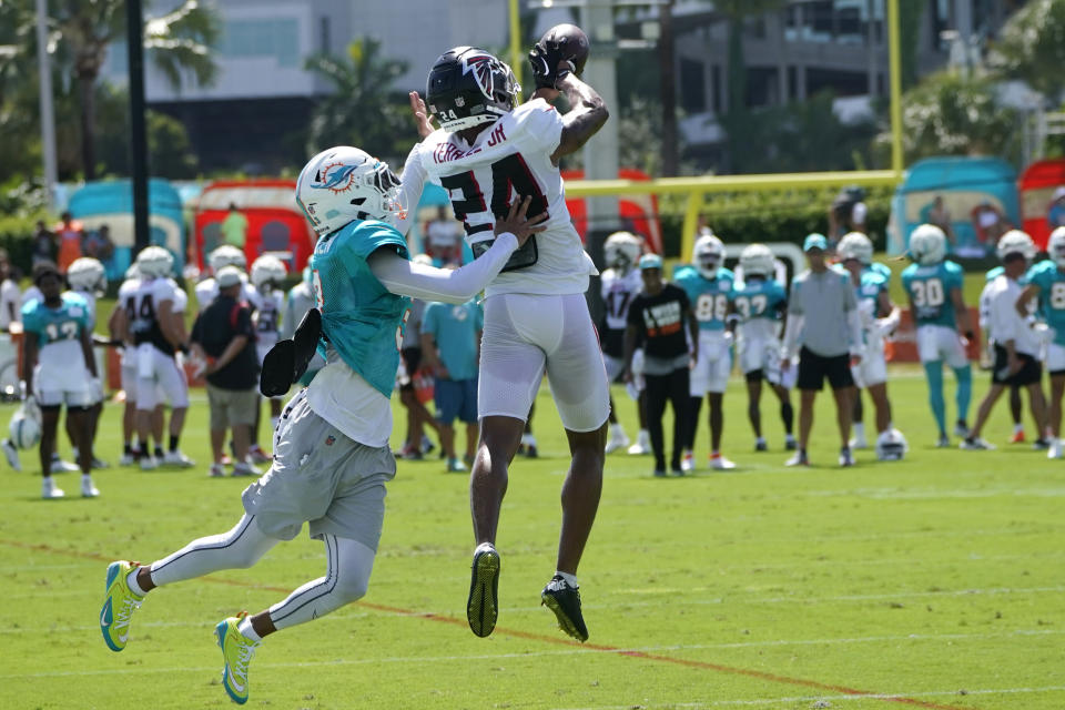 Atlanta Falcons cornerback A.J. Terrell (24) catches a ball intended for Miami Dolphins wide receiver Robbie Chosen, left, during a joint practice at the NFL football team's training facility, Tuesday, Aug. 8, 2023, in Miami Gardens, Fla. (AP Photo/Lynne Sladky)