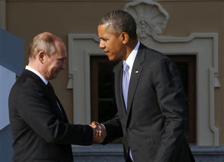 Russia's President Vladimir Putin (L) welcomes U.S. President Barack Obama before the first working session of the G20 Summit in Constantine Palace in Strelna near St. Petersburg, September 5, 2013. REUTERS/Grigory Dukor